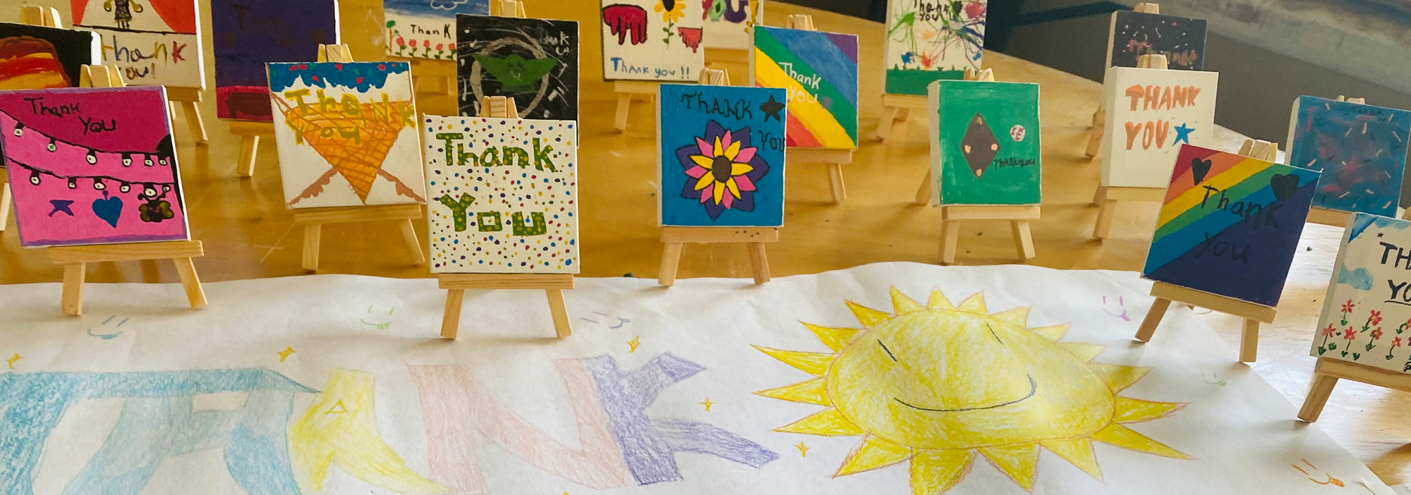 a group of children's artwork displayed on easels