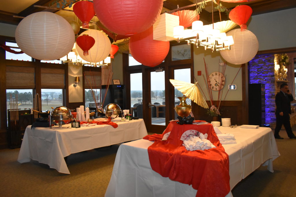 buffet tables with red and white lanterns hanging above