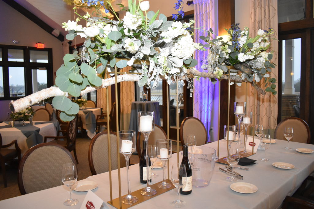 giant white flower center piece with candles and wine