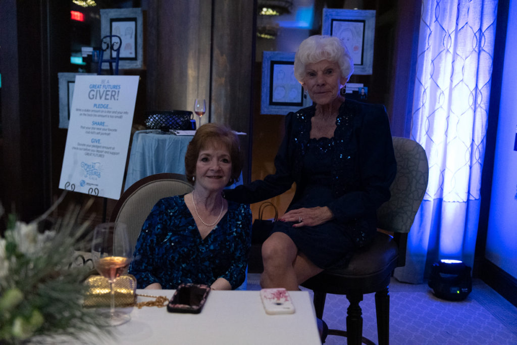 two old ladies dressed up at an event