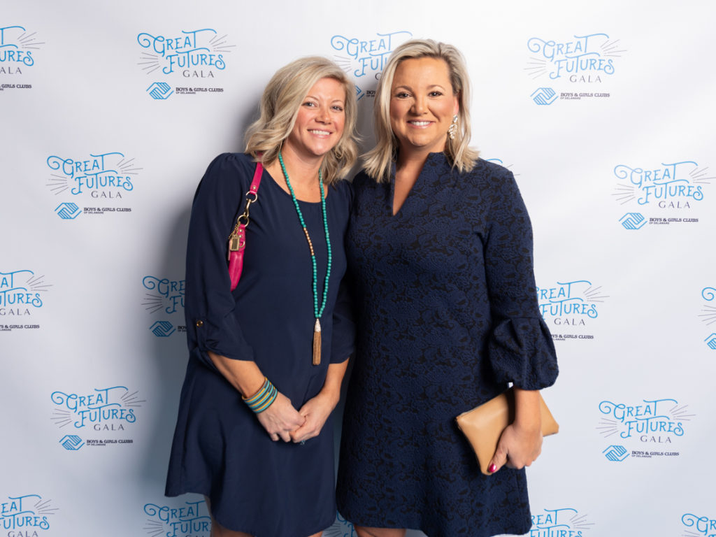two blonde girls in blue dresses at the great futures gala