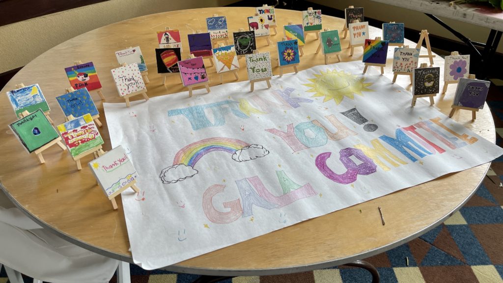children's artwork displayed on a wood table