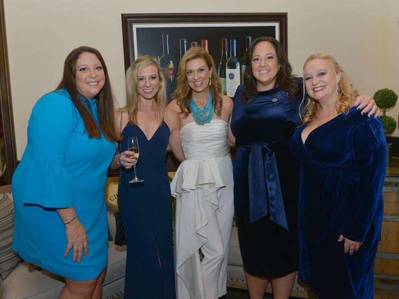five women in formal dresses